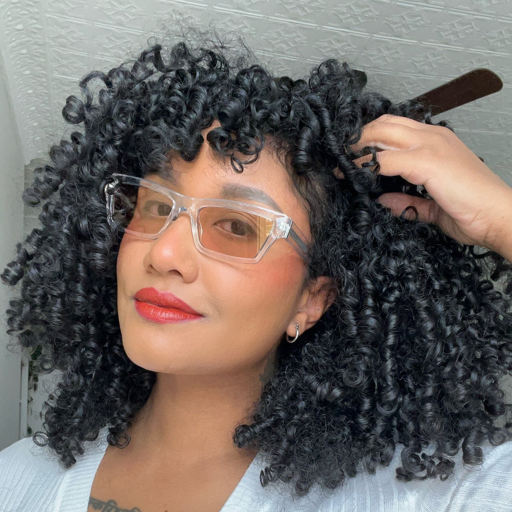 customer content - curlsbymarina  wearing dime optics laurel cat eye sunglasses with a translucent clear frame and rose pink with gold flash lenses front view