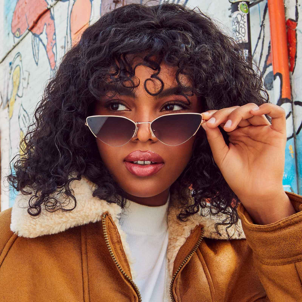 customer content - female wearing dime optics fairfax cat eye sunglasses with a brushed gold frame and sharp brown gradient lenses