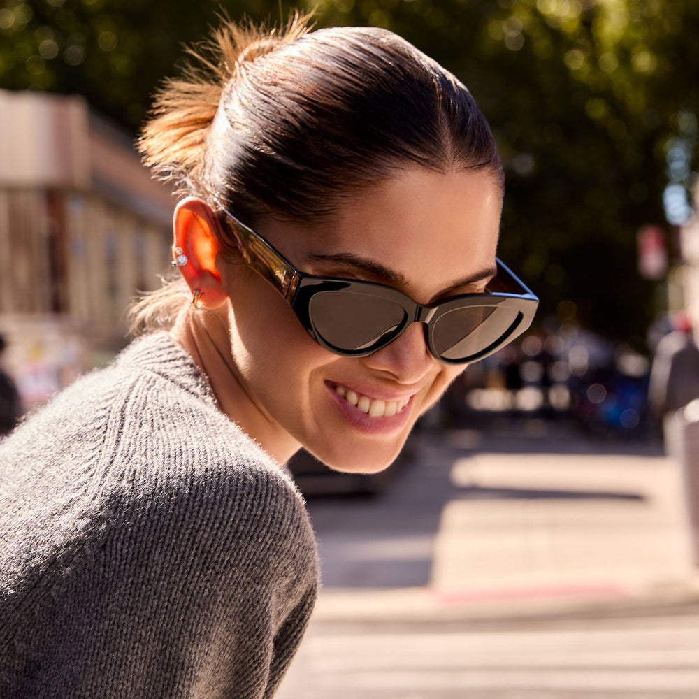 on model - les do makeup x dime optics featuring last call cat eye sunglasses with a black frame and grey polarized lenses front view