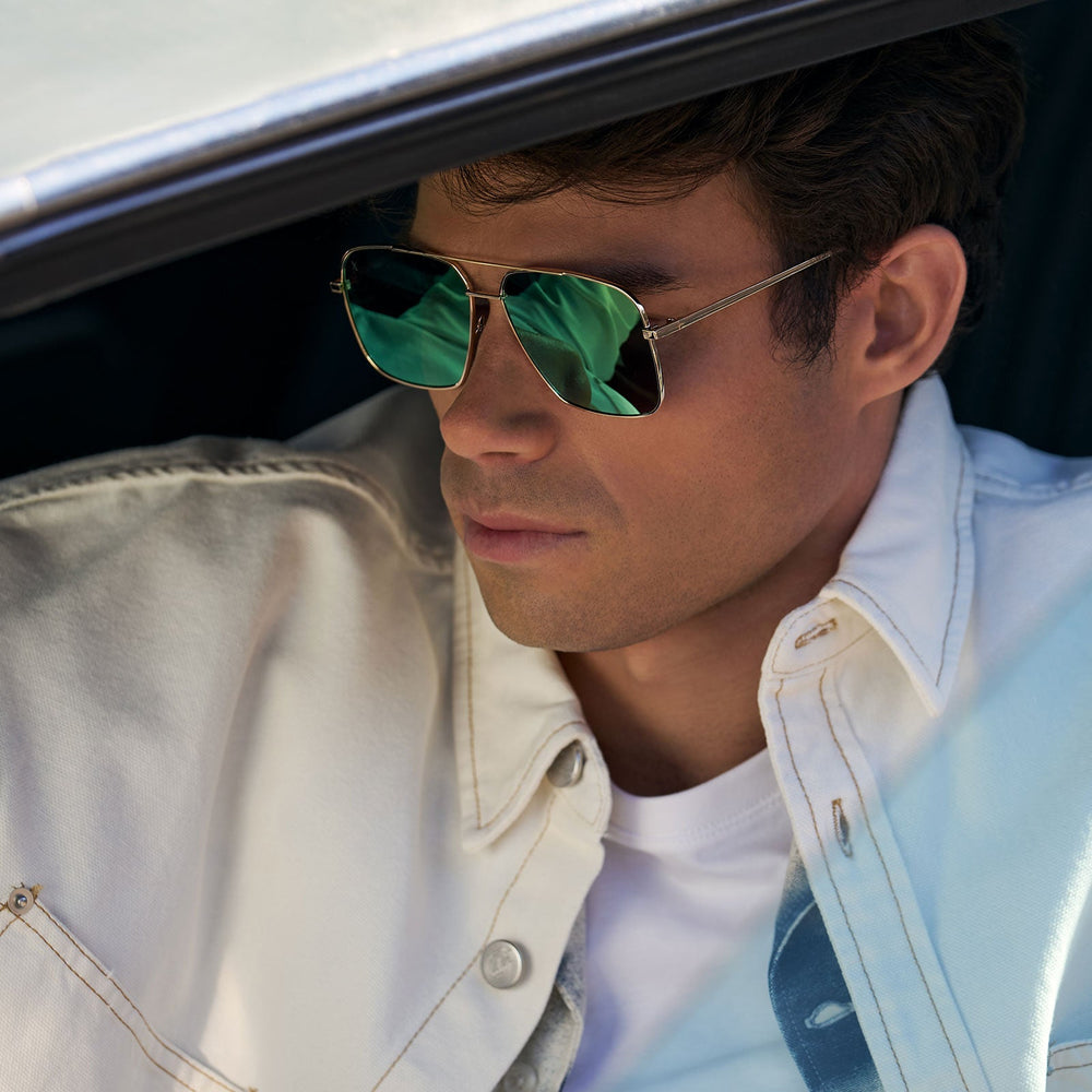 on model - male wearing dime optics encino aviator sunglasses with a gold metal frame and cyan mirror lenses detailed view