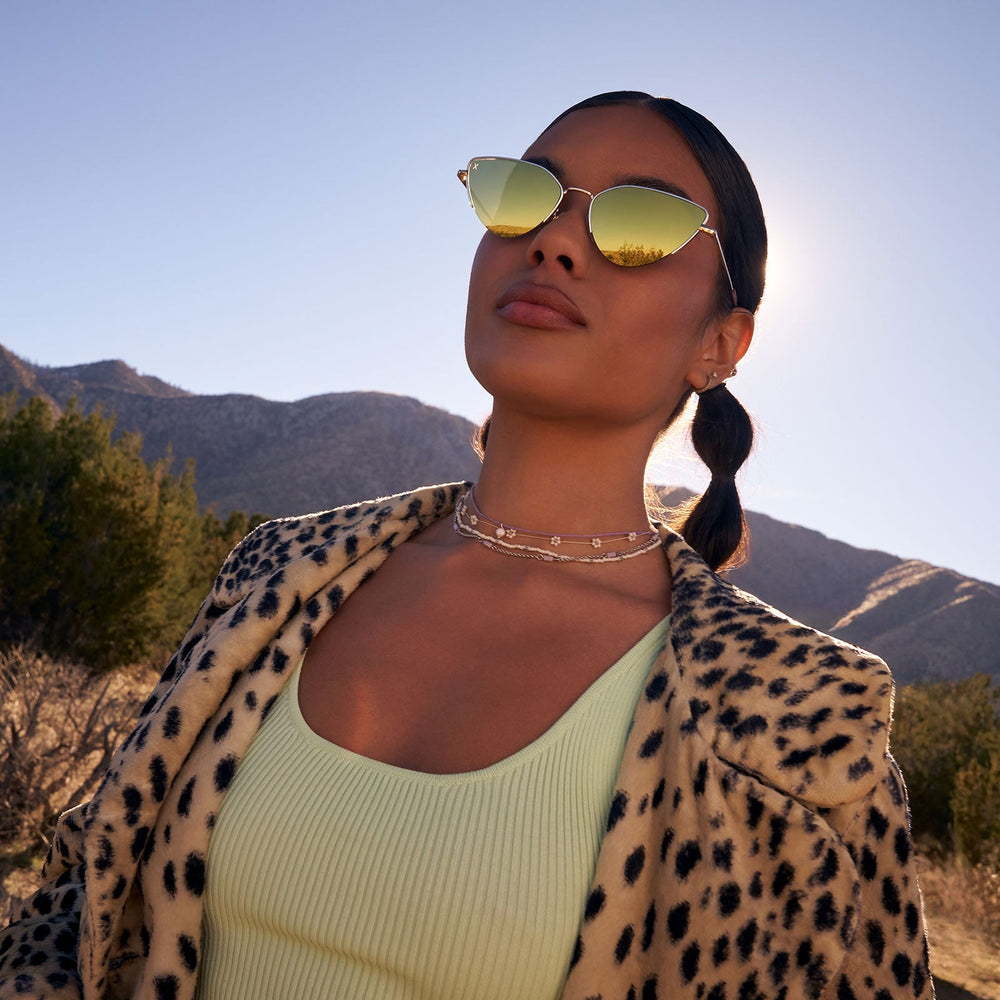 on model - female wearing dime optics fairfax cat eye sunglasses with a gold metal frame and gold mirror lenses front view