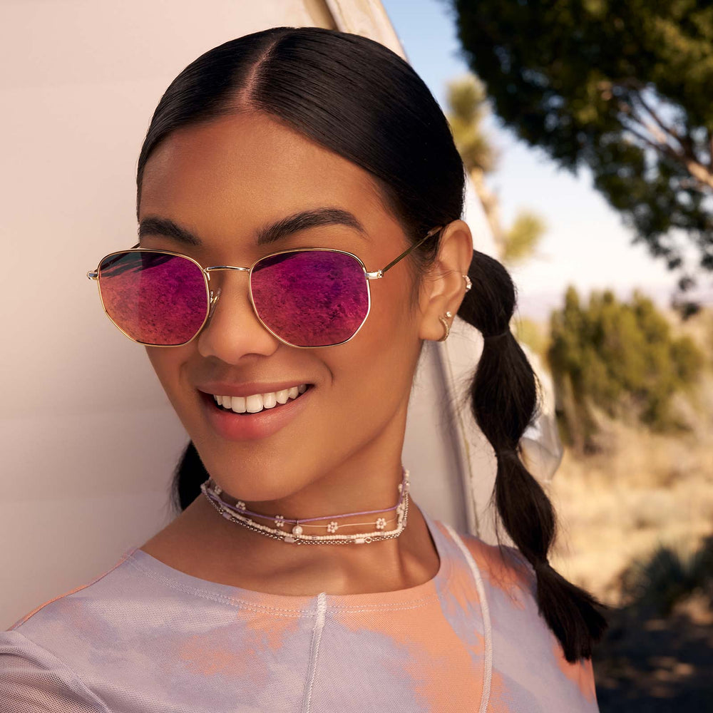 on model - female wearing dime optics roxbury round sunglasses with a gold metal frame and candy pink mirror polarized lenses front view