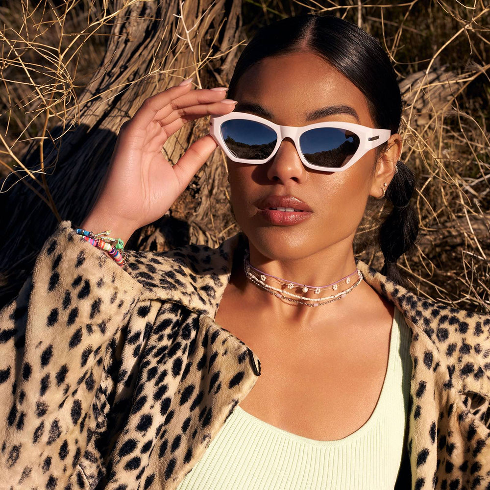 on model - female wearing dime optics sawtelle cat eye sunglasses with a glossy white frame and silver mirror polarized lenses front view