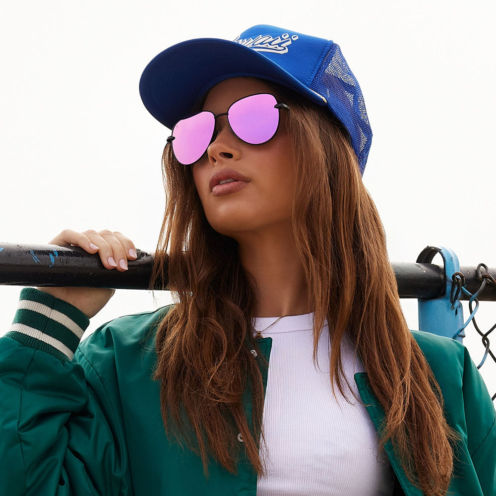 on model - female wearing dime optics abbot aviator sunglasses with a matte black frame and pink mirror polarized lenses front view