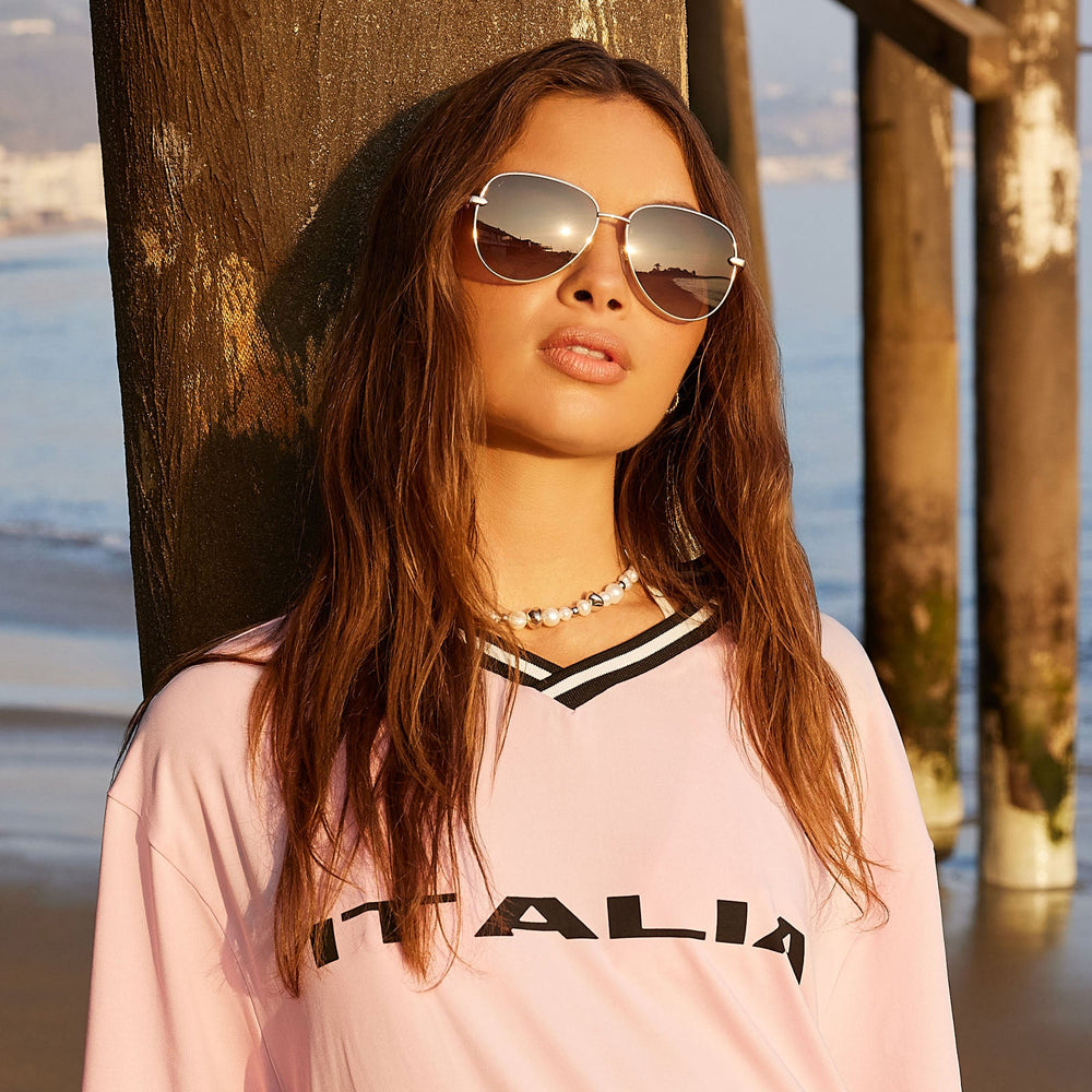 on model - female wearing dime optics abbot aviator sunglasses with a gold frame and brown gradient polarized lenses front view