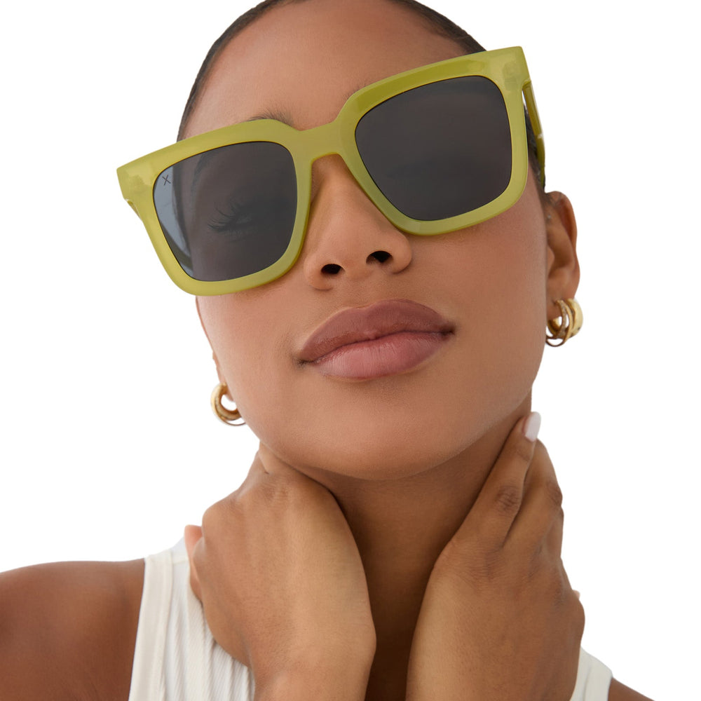 on model - female wearing dime optics featuring the malibu square sunglasses with a valley green frame and grey polarized lenses front view