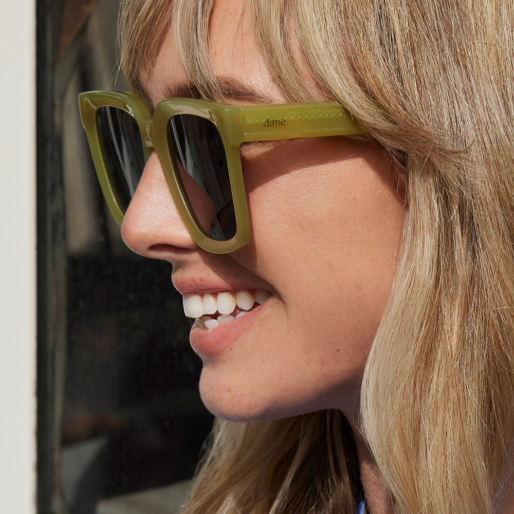 on model - female wearing dime optics featuring the malibu square sunglasses with a valley green frame and grey polarized lenses detailed view