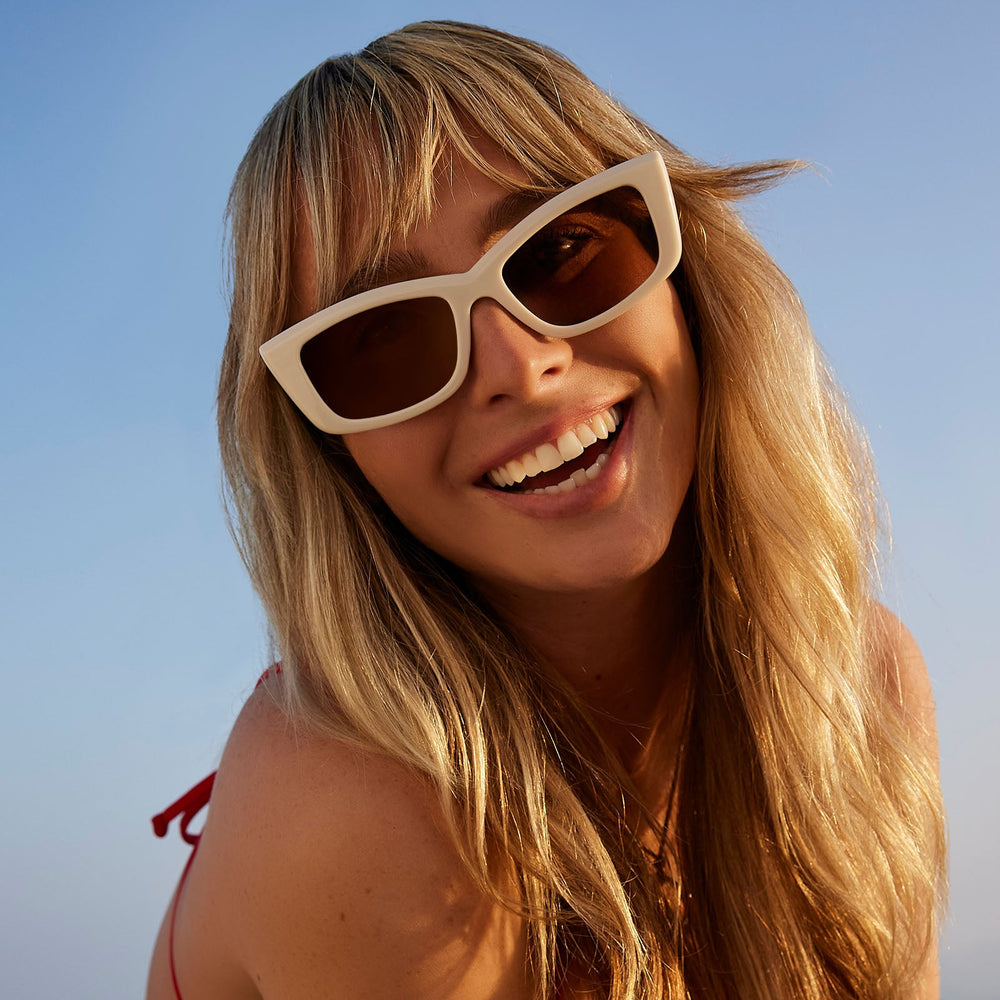 on model - female wearing dime optics olympic cat eye sunglasses with a swiss coffee cream frame and brown polarized lenses front view