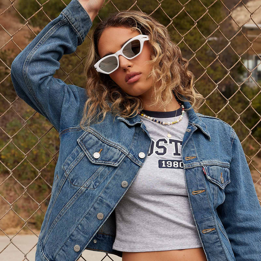 on model - female wearing dime optics sawtelle cat eye sunglasses with a glossy white frame and silver mirror polarized lenses front view