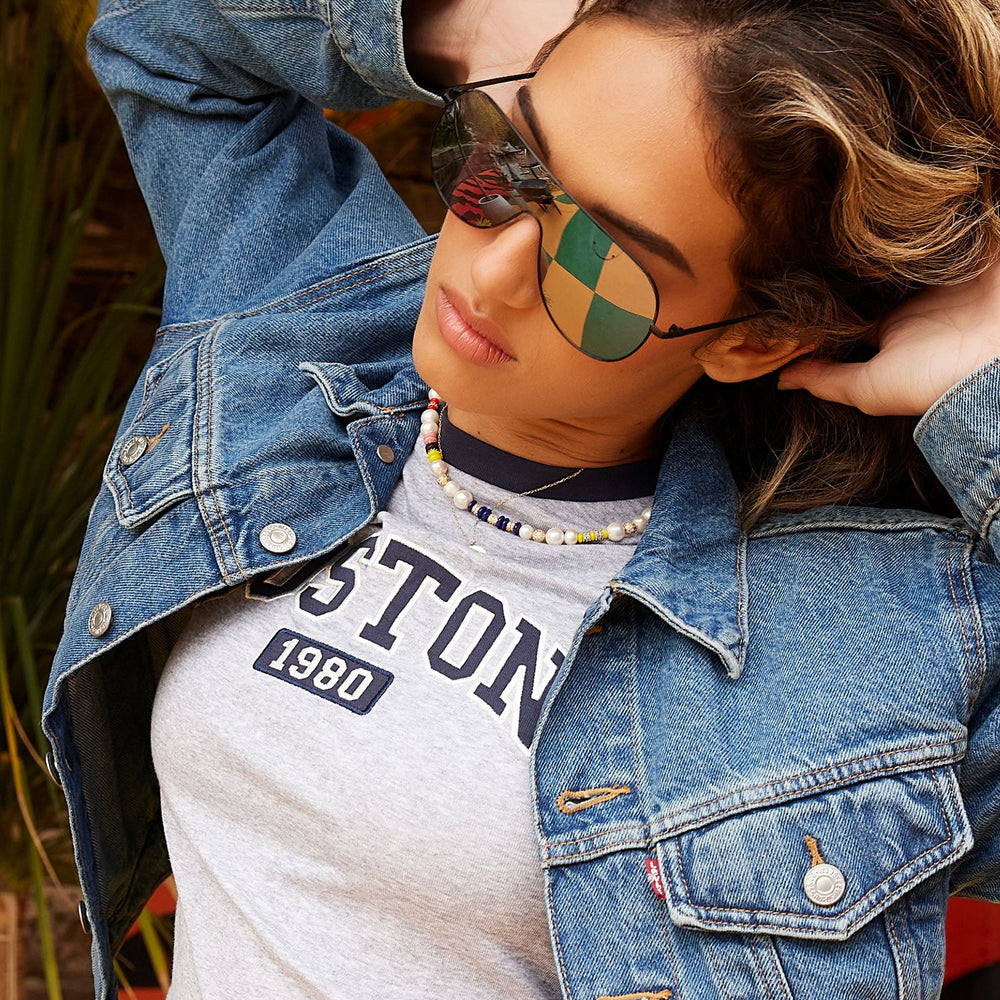 on model - female wearing dime optics tarzana shield sunglasses with a black metal frame and grey with silver flash polarized lenses detailed view