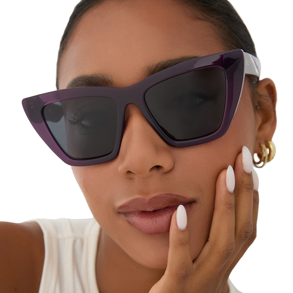 on model - female wearing dime optics featuring the windsor cat eye sunglasses with a amethyst purple frame and grey polarized lenses front view