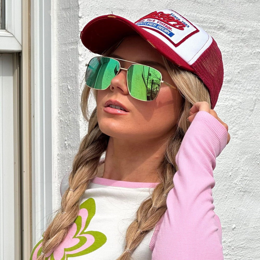 customer content - mariel higgs wearing green reflective aviators outside front view