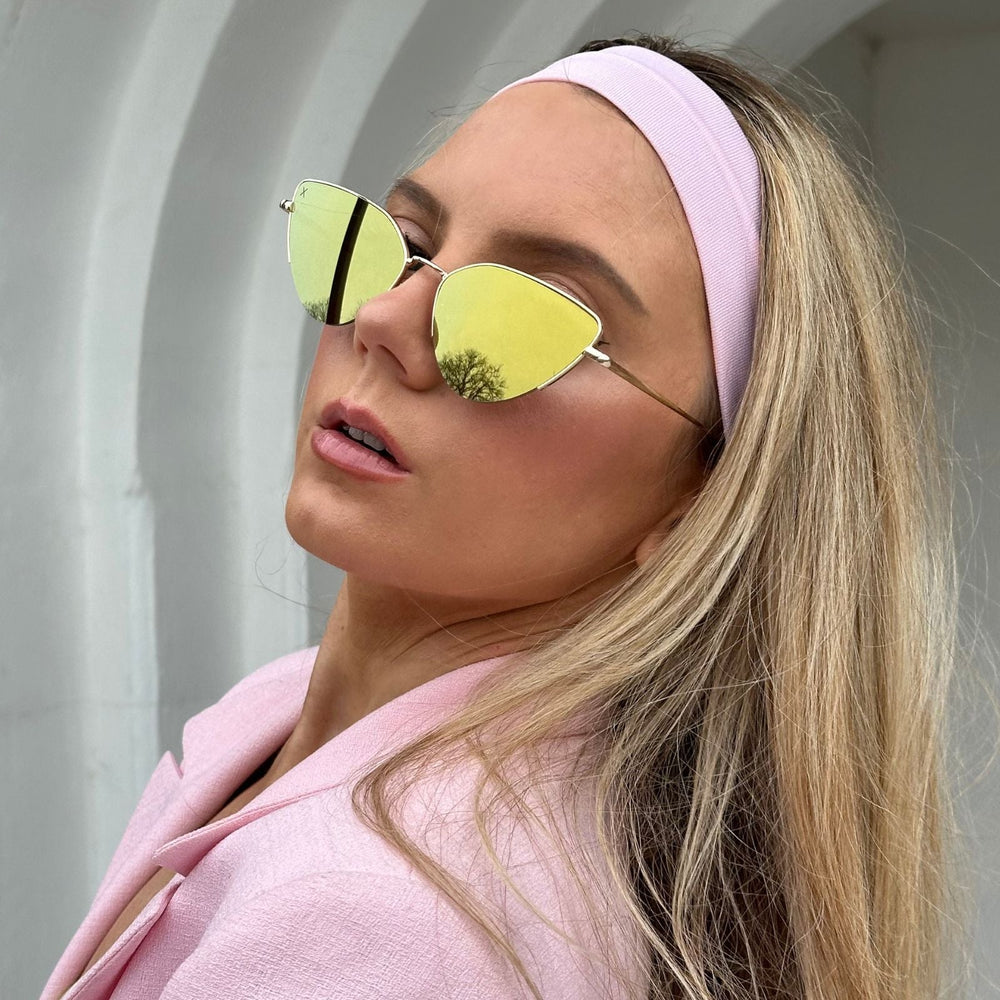 customer content- mariel higgs wearing gold sunglasses with pastel pink headband and blazer
