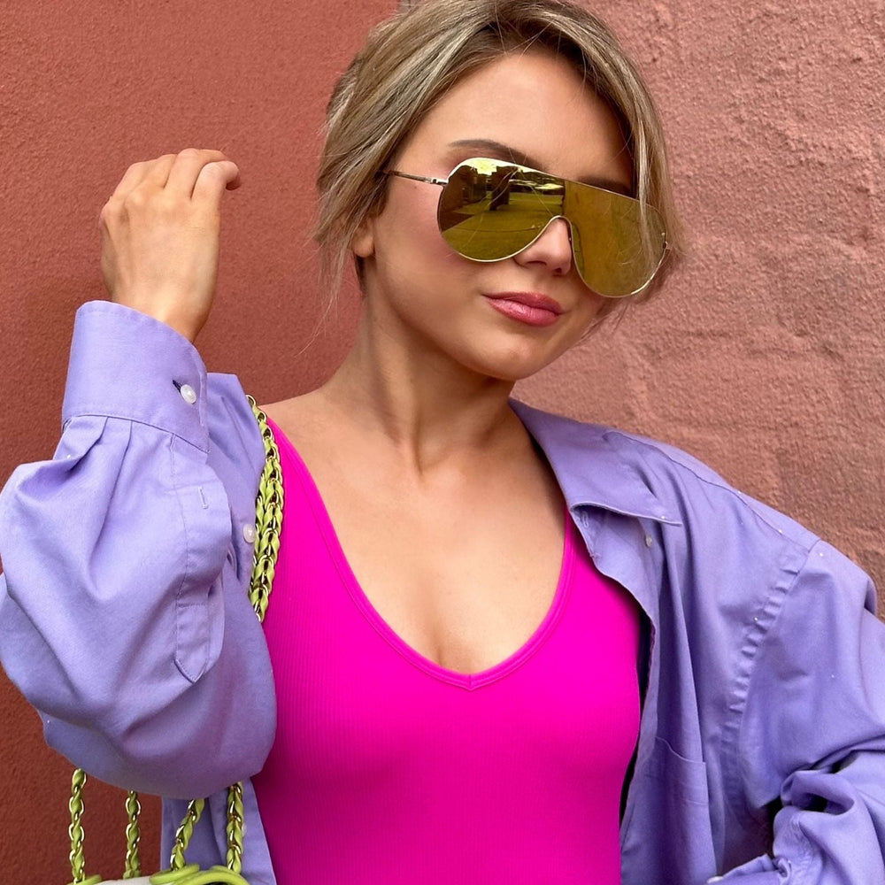 customer content - mariel higgs wearing dime optics tarzana shield sunglasses with a brushed gold metal frame and gold mirror polarized lenses front view