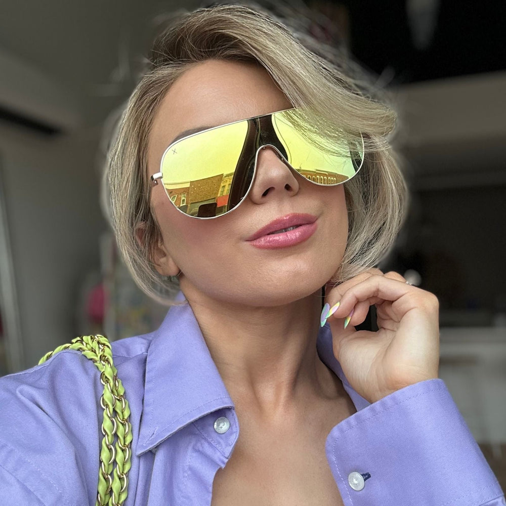 customer content - mariel higgs wearing dime optics tarzana shield sunglasses with a brushed gold metal frame and gold mirror polarized lenses front view