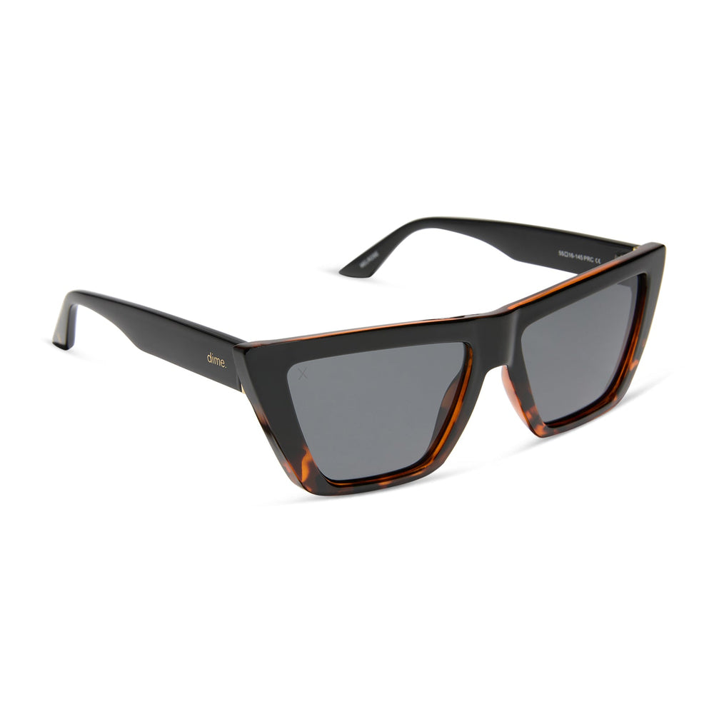 dime optics melrose cat eye sunglasses with a black tortoise frame and solid grey lenses angled view