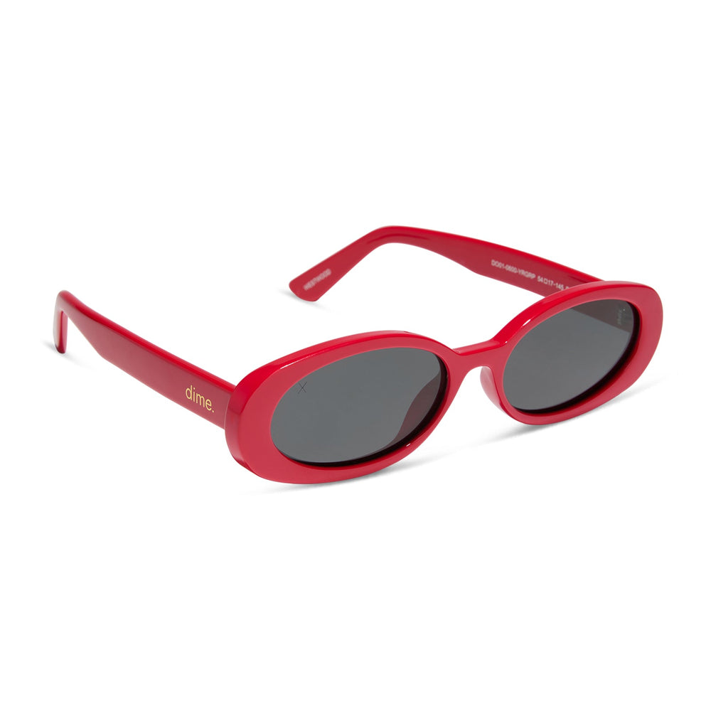 dime optics westwood round sunglasses with a ruby red frame and grey polarized lenses angled view