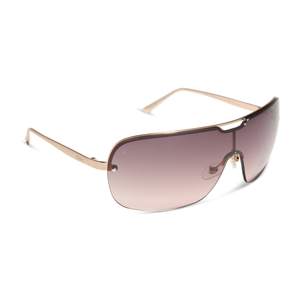 dime optics wilshire shield metal sunglasses with a brushed rose gold frame and rose gradient lenses angled view